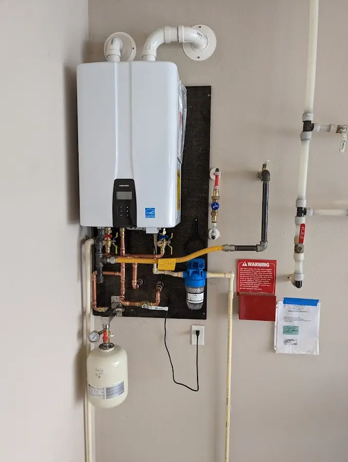 Professional plumber installing copper piping in a Tuscumbia home